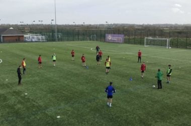 Footballers being coached during a training session