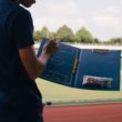 A man planning football tactics on a clipboard