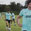 Man smiling during a football training session